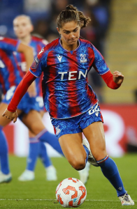 Macron Crystal Palace Player wearing Macron Woman Fit Teamwear